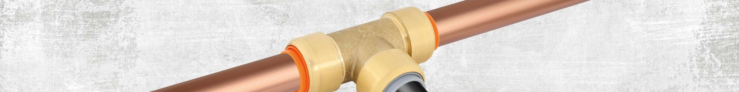 Two copper bars connected to a brass tee.
