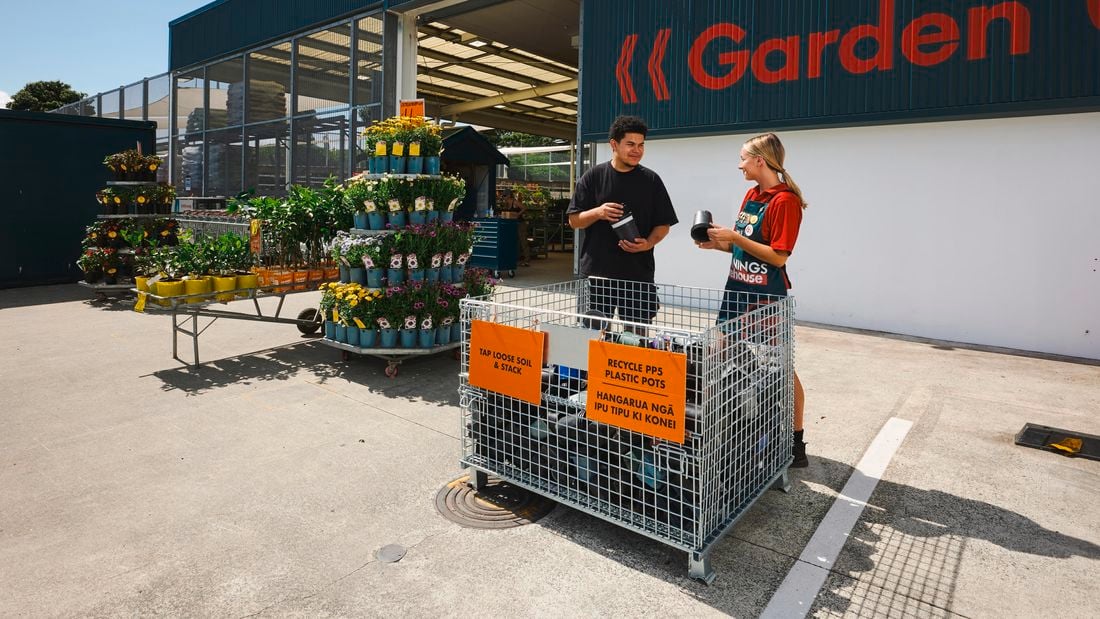 Pot recycling project with team and customer in front of cage