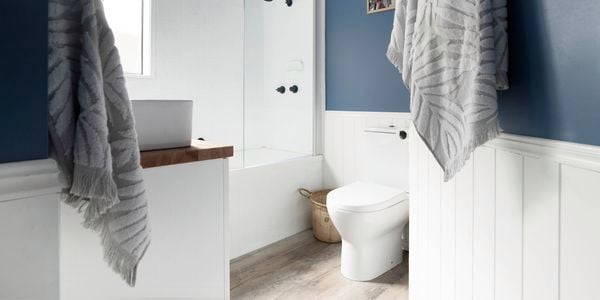 Hamptons style bathroom with bathtub and towels in shot