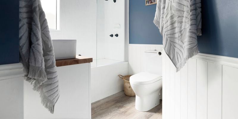 Hamptons style bathroom with bathtub and towels in shot