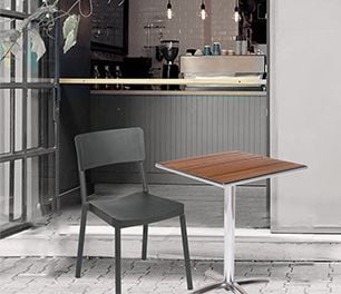 Chair and table in front of a small bar