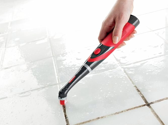 Power Scrubber cleaning grout.