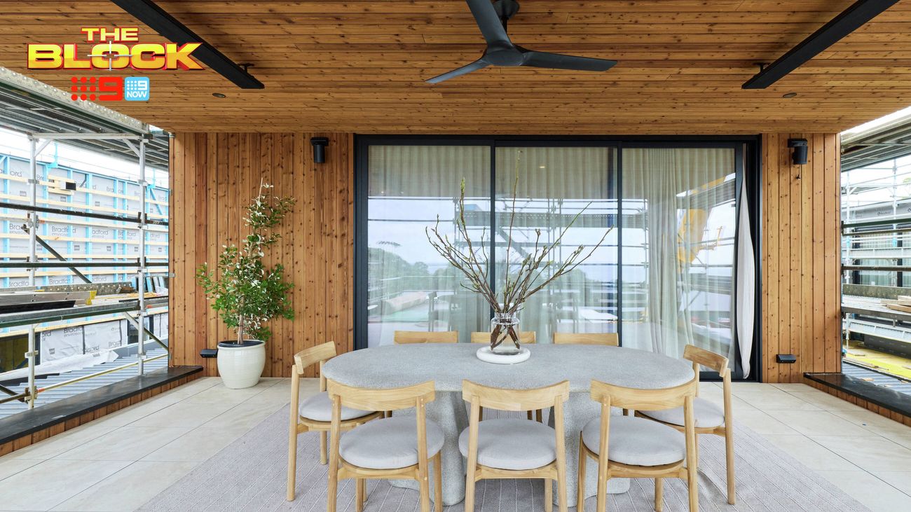 Covered outdoor dining area featuring a timber table and chairs, timber-lined walls and ceiling, and a large ceiling fan.