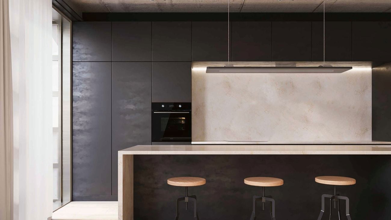 Minimalist black and grey kitchen with modern stools and black oven.