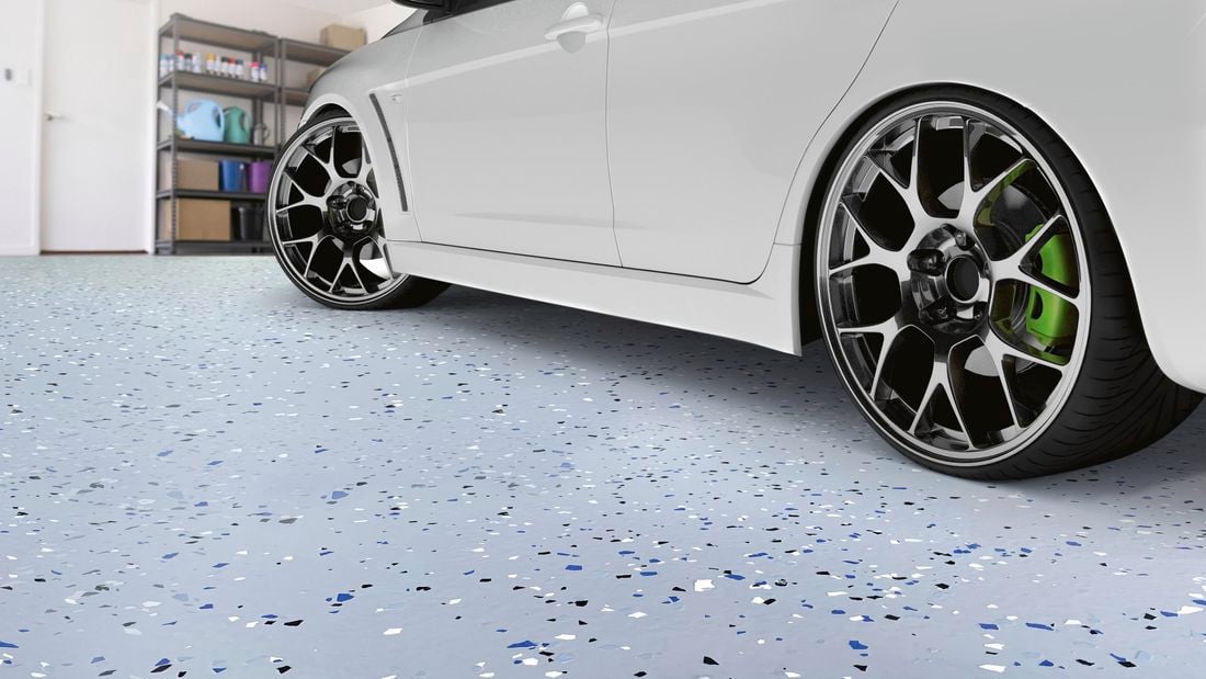 Close up of a car on a finished epoxy garage floor.