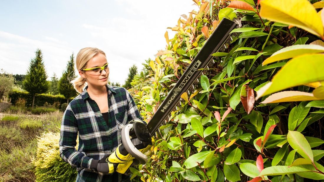 person using a hedge trimmer