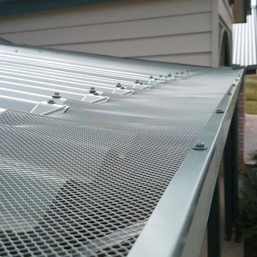 Close up of a roof image with an installed gutter mesh.