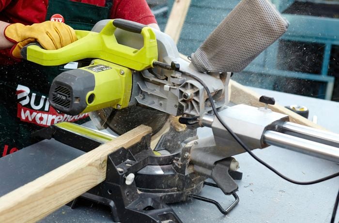 Person sawing timber.