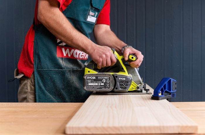 Bunnings team member cutting timber with a power saw