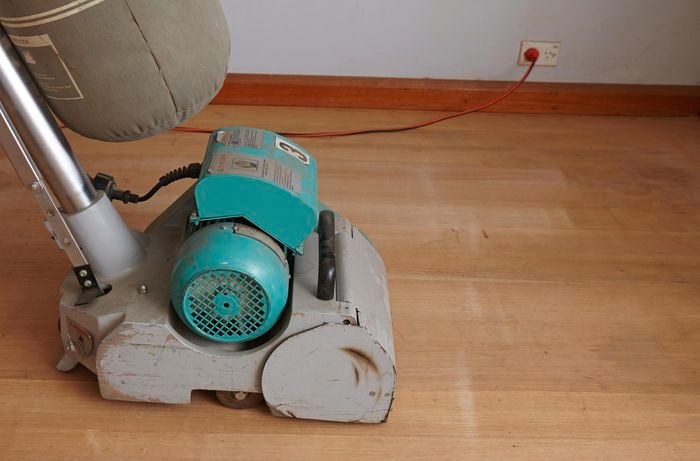 A floor sander on a hardwood floor