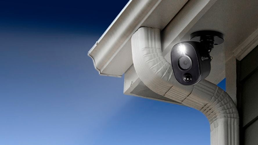 Security camera under the eave of a house exterior