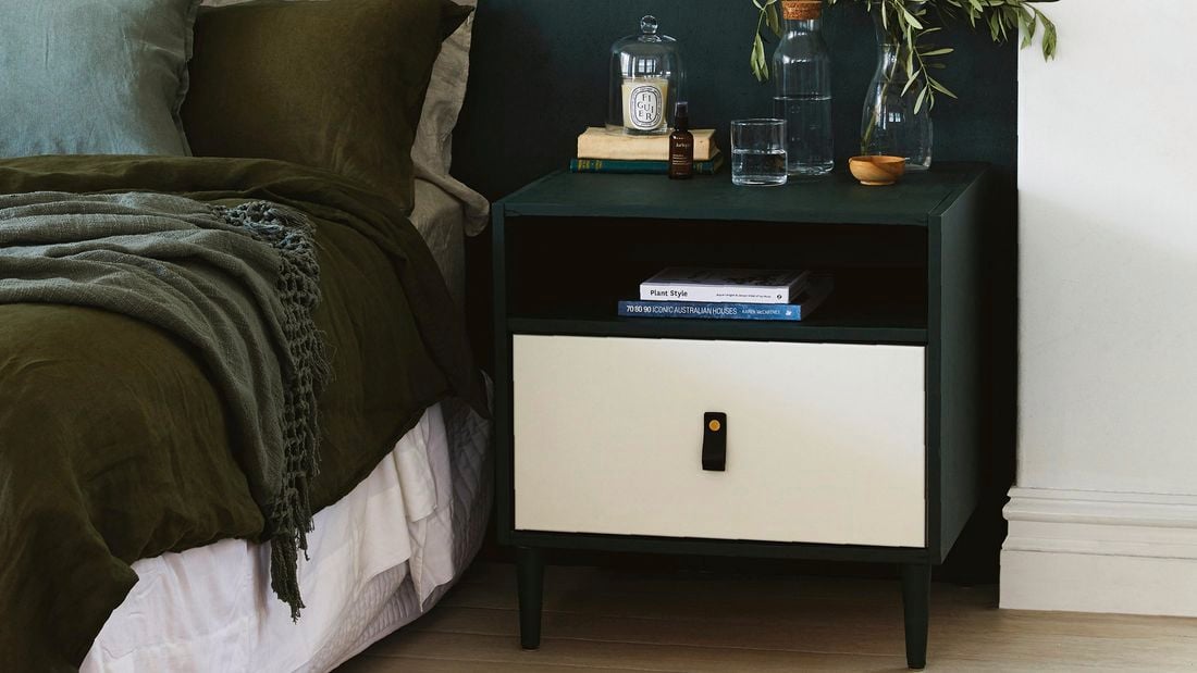 Black and white bedside table in bedroom.