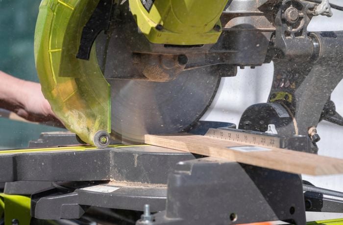 Cutting the trim to size using a circular saw.