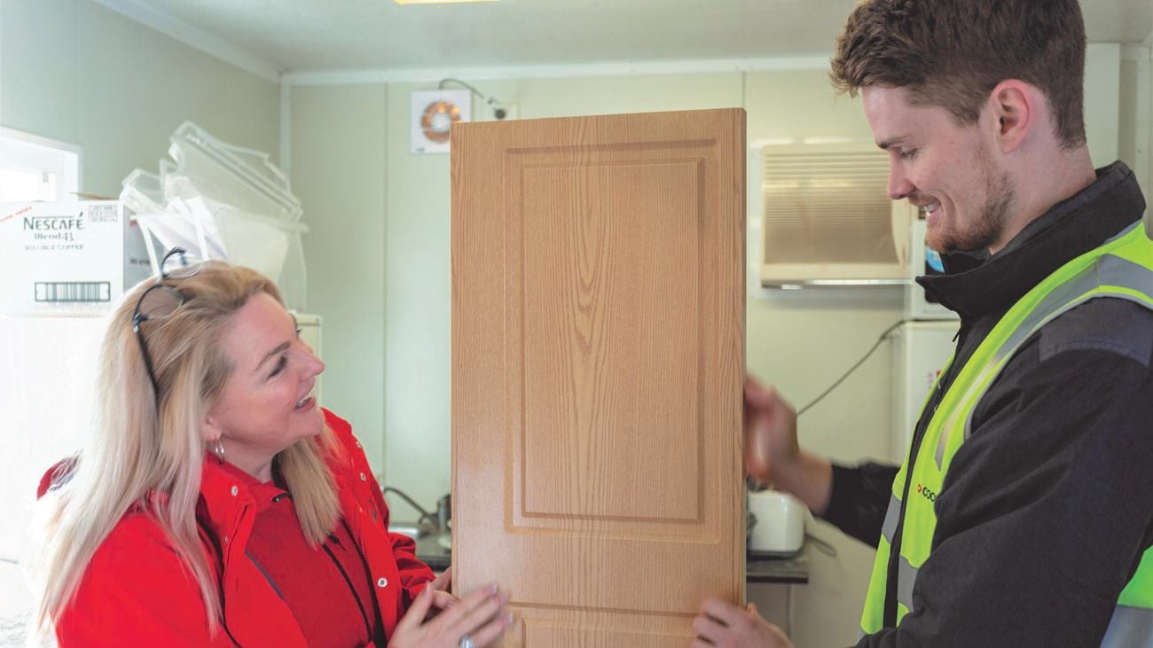 People inspecting a newly manufactured door