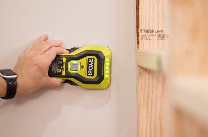 Use a stud finder to locate studs on a wall 