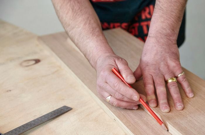 Marking a piece of timber for cutting