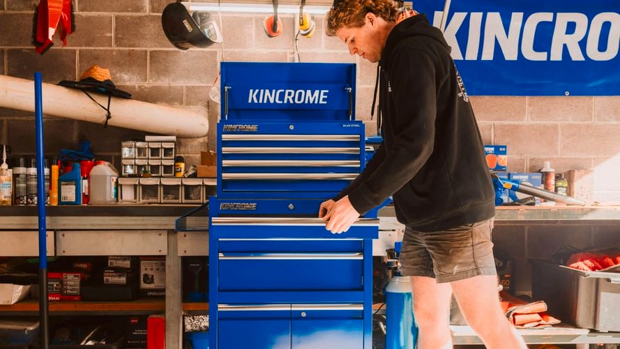 A man using a tool chest trolley.