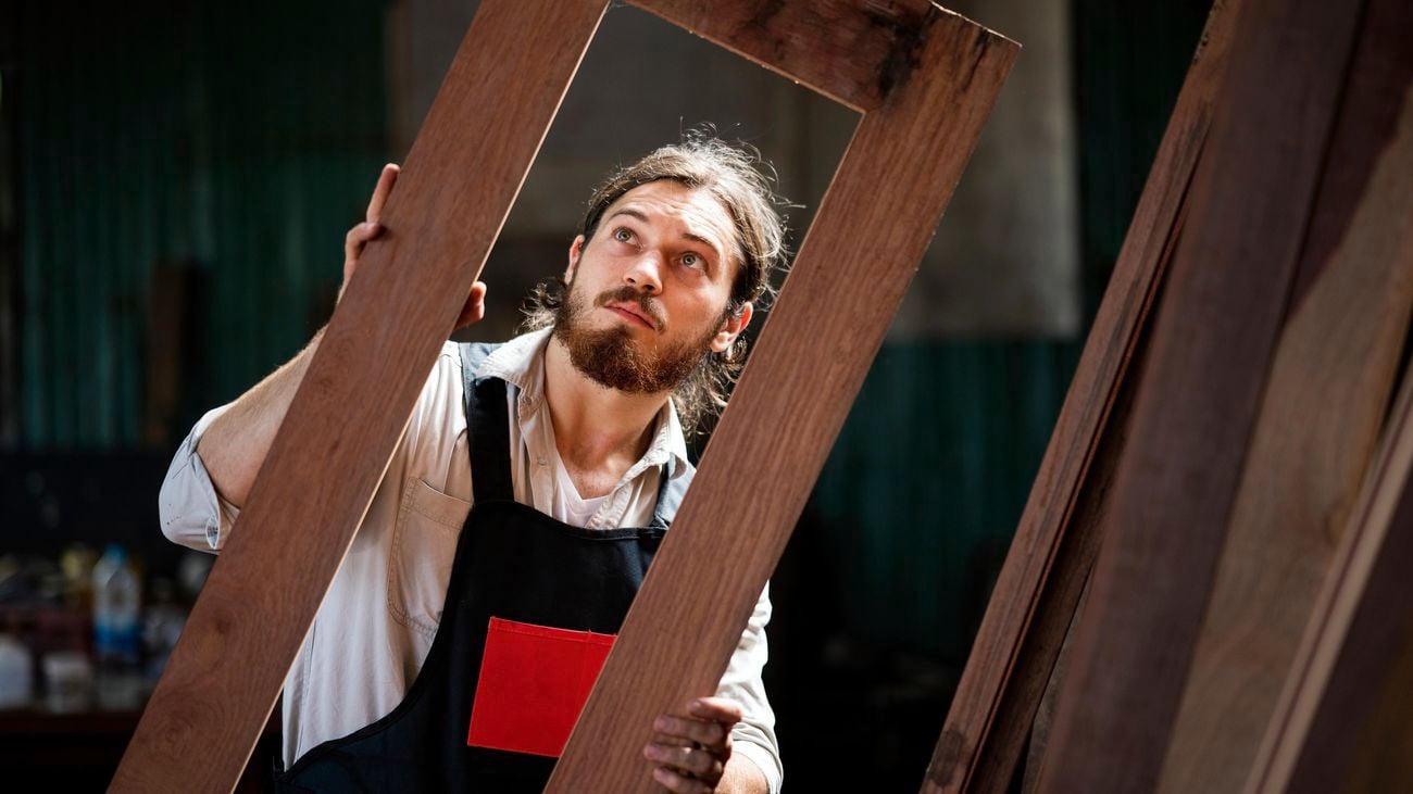 Carpenter examining a wooden door frame