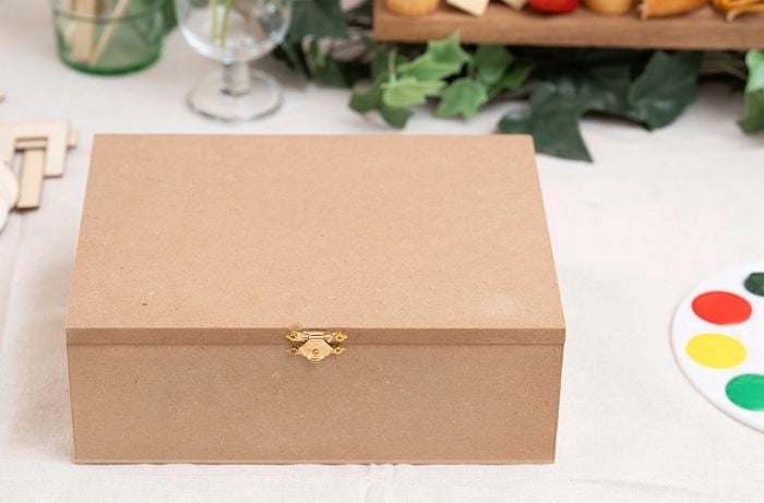 A plain wooden craft box placed on a work surface, ready to be decorated and transformed into a personalised memory box