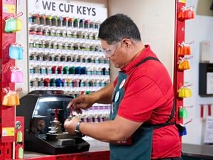 Team member using the key cutting machine 