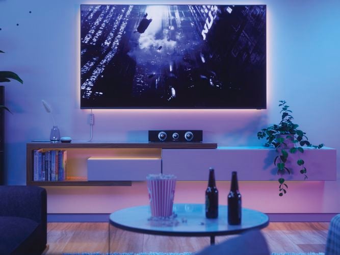 Smart LED light strips mounted onto a wall behind a TV in the living room.