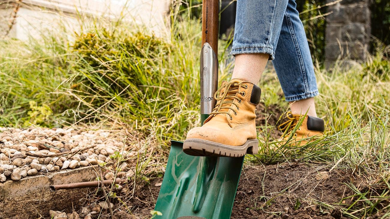 A person digging soil with a shovel