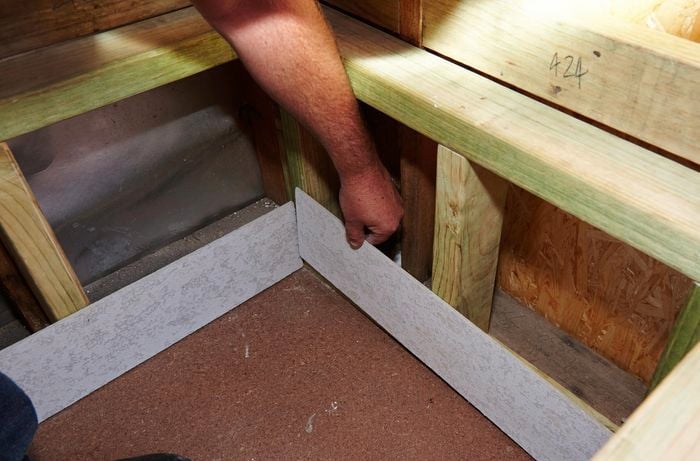 Person installing fibre cement lining.