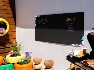 A completed chalkboard wall panel used to display a BBQ menu in an outdoor space.