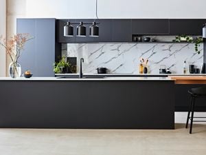 Modern Kitchen with matte finish cupboards, marble splashback and a floating dining bench area.
