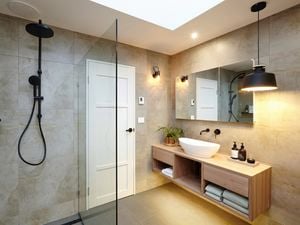 A modern bathroom with a basin, mirror and shower