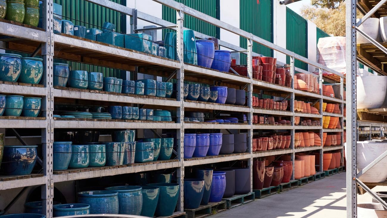 Racking filled with terracotta pots in an outdoor nursery in a Bunnings store