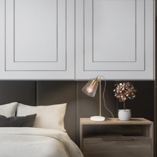 Bedroom with bed, bedside table and a lamp 