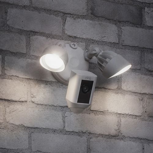 Unit with a security camera with two lights mounted next to a front door