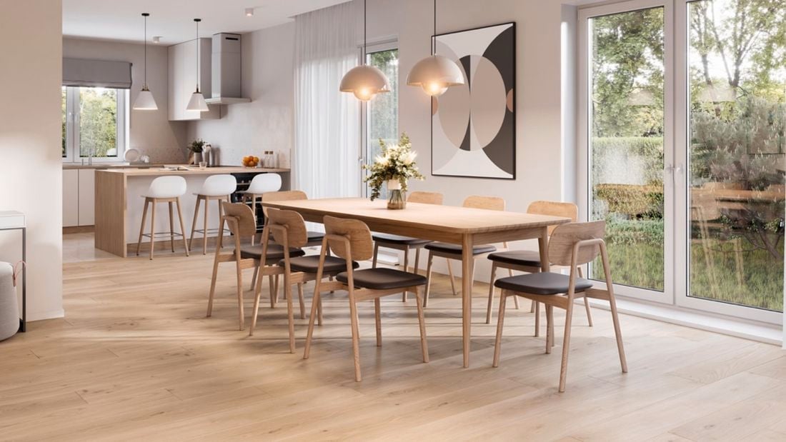 A spacious modern dining area with hanging lights near a kitchen