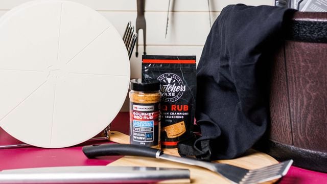Close up of BBQ rub products and BBQ tools.