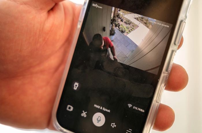 A person checking security cameras using his phone.