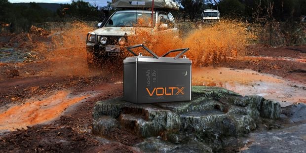 VoltX battery in prime spot with two off road vehicles being used in muddy terrain. 