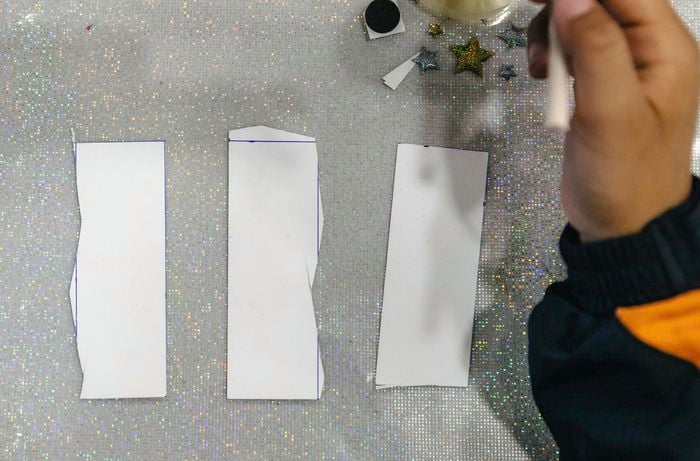 Three rectangles of cardboard cut out with scissors