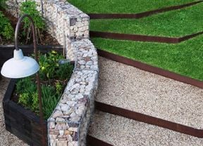 Luscious green grass steps with rock retaining wall
