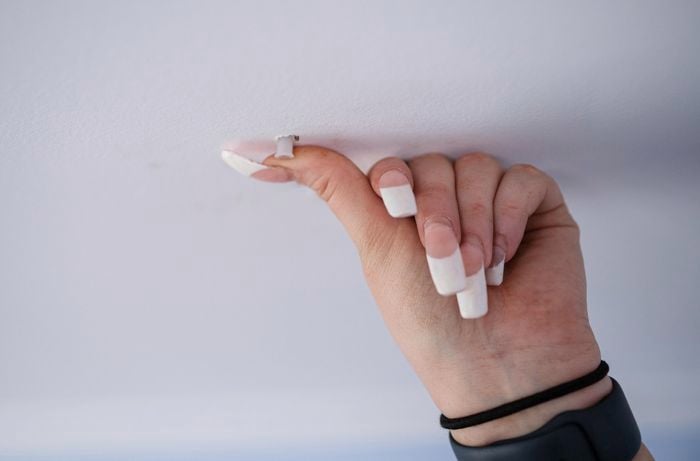 A person inserting plastic plugs. 