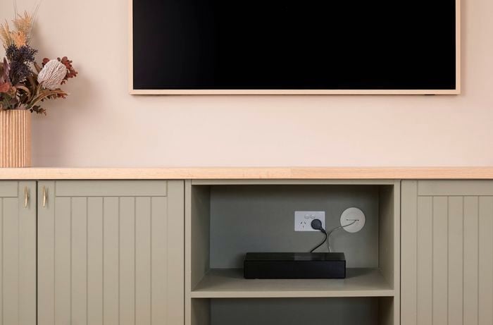 Image of a mounted TV with hidden cables using grommets.