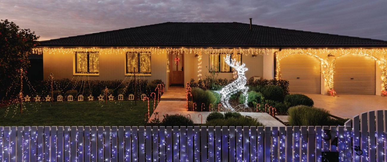 front of house that has been decorated in Christmas lighting