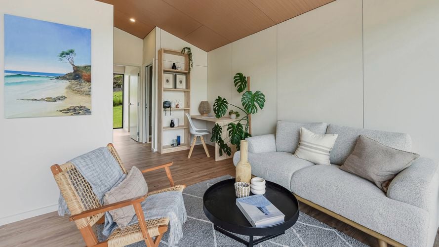 Contemporary living room with sofa, armchair, study nook and timber feature ceiling.