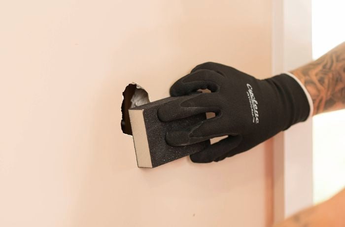 Sand the paint around the hole using a sanding block