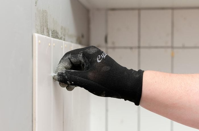making sure they evenly space the tiles