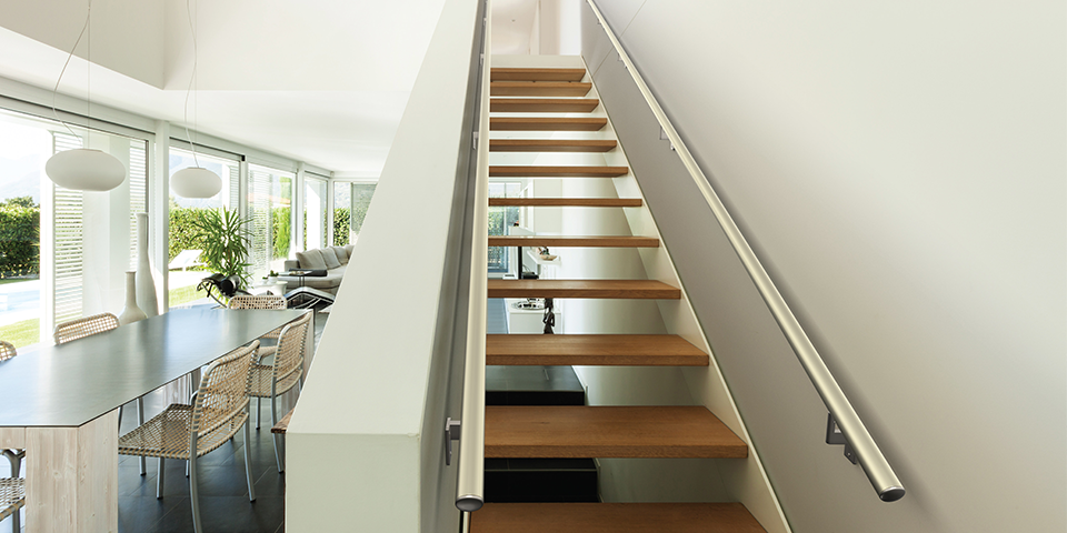 Internal timber stairs with polished metal handrails