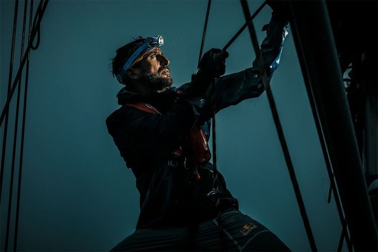 Person sailing at night with headtorch on