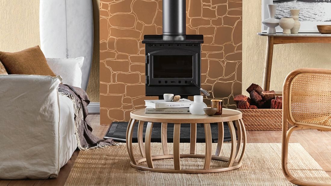 A lounge room with decorative wall panelling, couch, table and fireplace.