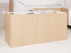 The image shows a nearly completed kitchen island bench cabinetry in a kitchen under construction.