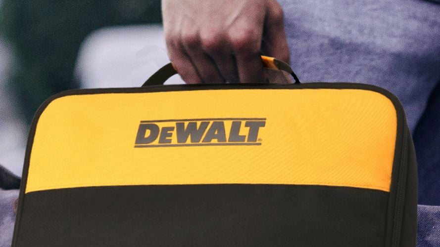 a person holding a yellow and black DeWalt-branded carrying case